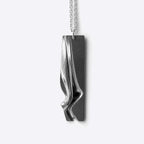 Nocturne Stainless Steel Pendant with twisting curves and precision edge detailing on a 22-inch chain