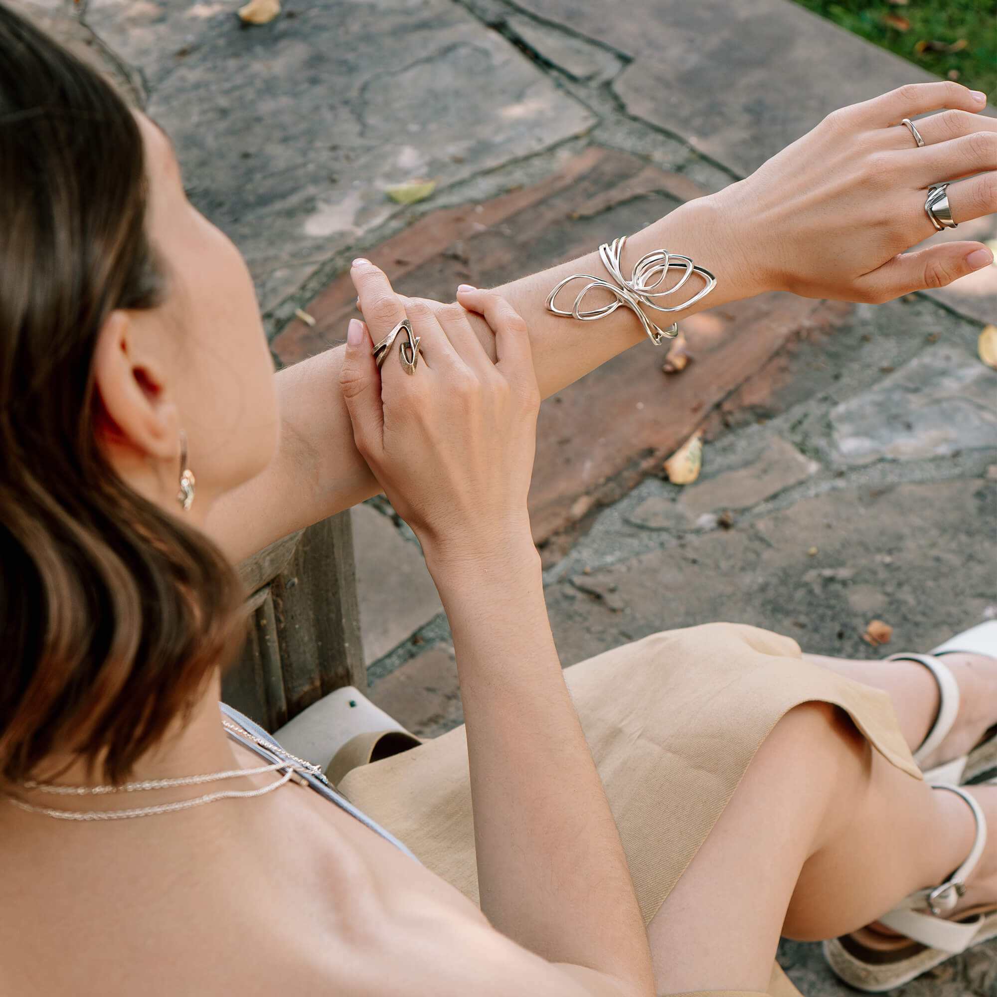 Velum Stainless Steel Ring with drapery-inspired curvature, open back design, worn on finger
