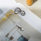 Nocturne Stainless Steel Pendant with twisting curves and precision edge detailing on a 22-inch chain