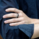 Amor Stainless Steel Ring bold twisted band on finger with dark shirt background