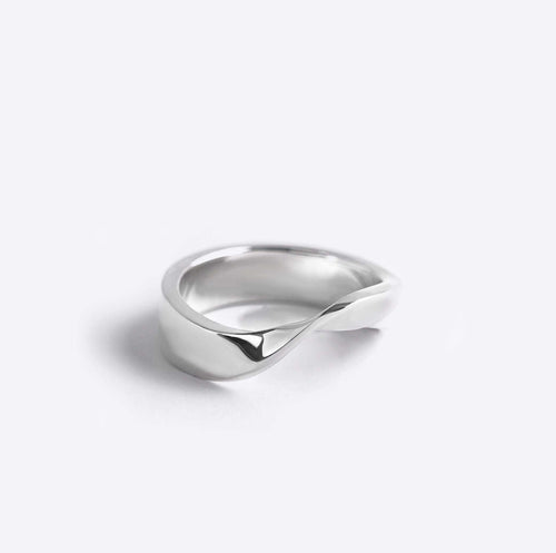 Sterling silver Amos Ring with a minimal twisted band and polished finish against a white background