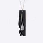 Nocturne Steel Pendant gray steel necklace with twisting stacking curves in modern design